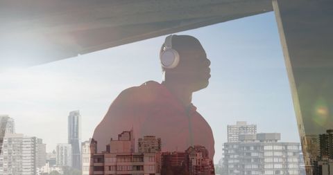 Man enjoying music with urban panorama in background