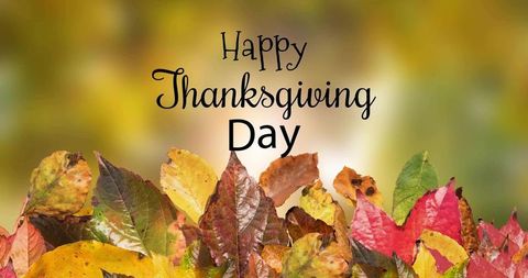 Happy thanksgiving day greeting card featuring colorful autumn leaves and warm bokeh