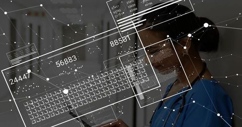 Doctor in scrubs analyzing digital interface in hospital