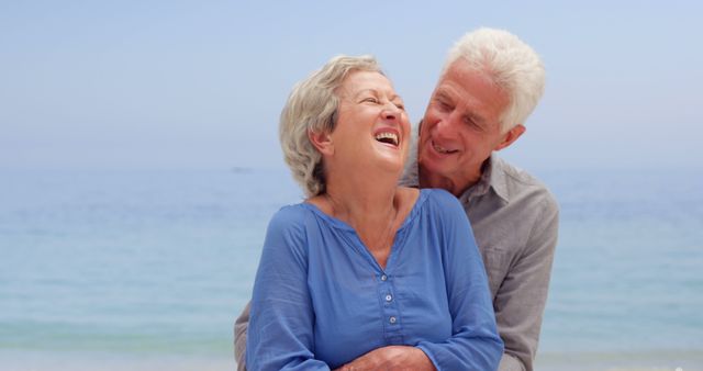 Old couple hugging on the beach