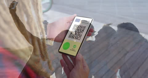 Man Holding Smartphone with COVID-19 Vaccine Passport Over Friends Selfie