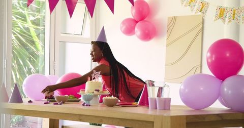 Woman Arranging Table for Children’s Birthday Party Celebration