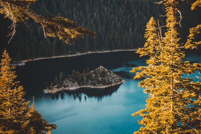 Stunning aerial view of a tranquil lake surrounded by autumn-colored forests. Highlighting a small island in the middle of the lake. Ideal for use in travel blogs, nature magazines, promotional materials, environmental campaigns, and relaxation-themed designs.
