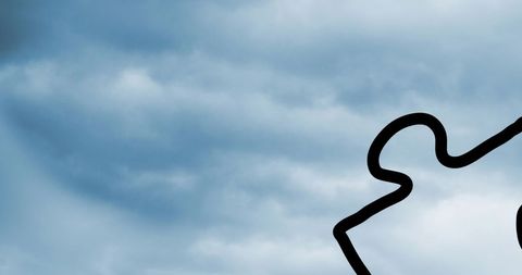 Puzzle and Question Marks Overlay on Cloudy Sky