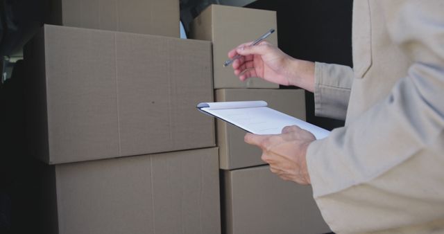 Logistics professional checking inventory at a warehouse - Download Free Stock Photos Pikwizard.com