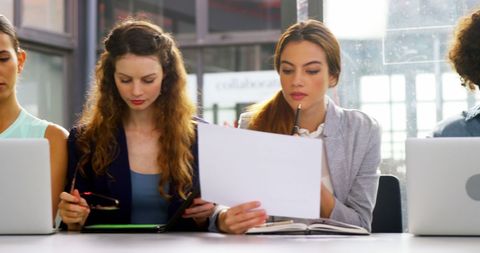 Young Professionals Collaborating on Digital Devices in Modern Office Setting - Download Free Stock Images Pikwizard.com