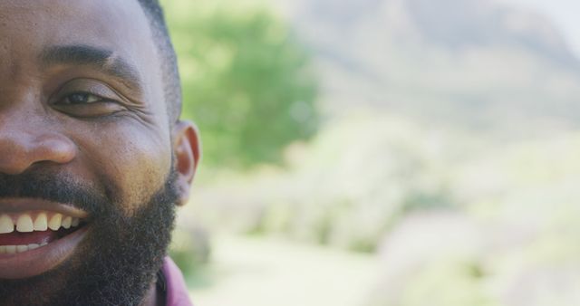 Close-up of Man Smiling Outdoors with Green Background - Download Free Stock Images Pikwizard.com