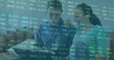 Couple analyzing investment data on tablet with transparent stock ticker overlay