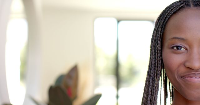 Young Woman Smiling With Braided Hair in Bright Room - Download Free Stock Images Pikwizard.com