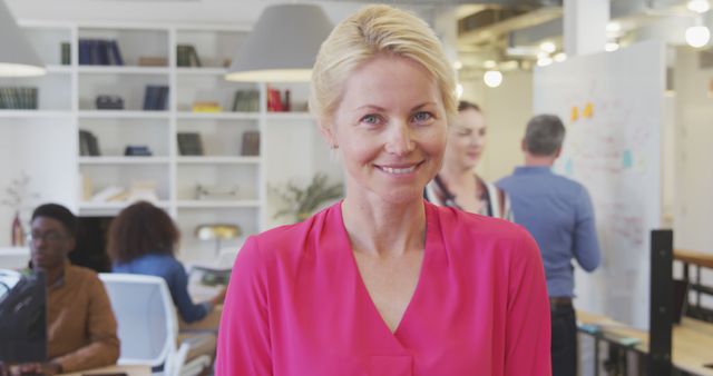 Smiling Businesswoman in Modern Open Office Environment - Download Free Stock Images Pikwizard.com