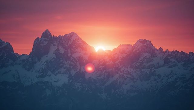 Majestic Sunrise Over Snow-Capped Alpine Mountains