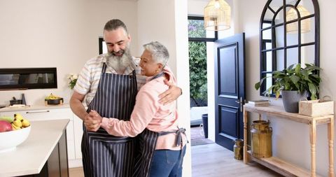 Senior Couple Dancing in Bright Modern Kitchen