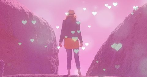 Dreamy landscape with hearts overlaying woman outdoors