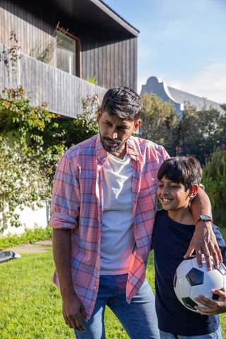 Father and Son Bonding Outdoors, Embracing Sports Togetherness