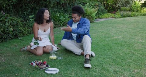 Couple Sharing Picnic Experience Outdoors on Sunny Day