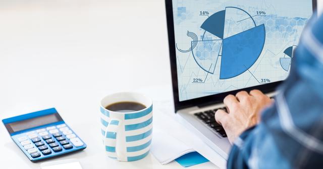 Man analyzing financial data on laptop with displayed pie charts, calculator, and coffee cup on table. Ideal for content related to business analysis, financial planning, accounting, economic reports, and office work environments.