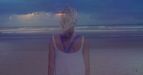 Contemplative Woman by Ocean during Dusk