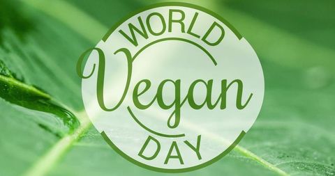 World Vegan Day Concept Text with Green Leafs Background