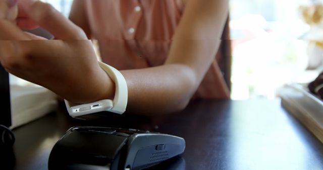 Teenage girl making payment through smartwatch in restaurant 4k