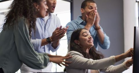 Diverse team celebrating success at work together