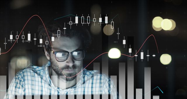 A bearded man wearing glasses intently looking at a computer screen displaying various stock market graphs and data. Useful for illustrating stock market analysis, financial technology, modern business operations, market research, and investment strategy planning.