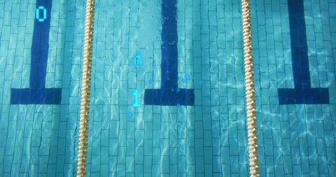 Minimalist top-down lap pool lane with beige rope dividers and blue water caustics