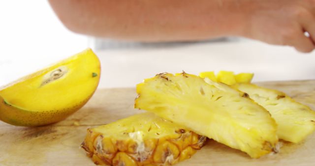 Close-Up of Freshly Sliced Pineapple and Mango on Cutting Board - Download Free Stock Photos Pikwizard.com