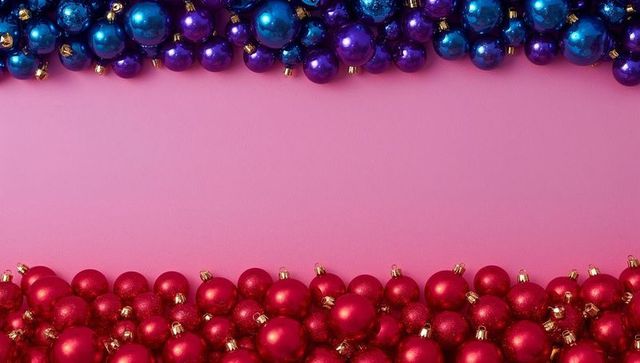 Framing festive bauble border on pink backdrop with blue, purple and red ornaments