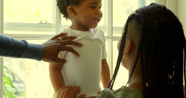 Happy Toddler with Family by Sunlit Window - Download Free Stock Images Pikwizard.com