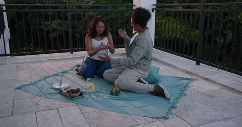 Couple Relaxing on Terrace with Picnic Basket