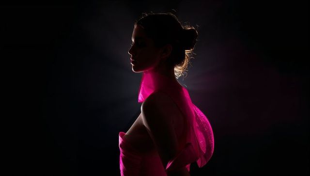 Elegant female silhouette in vibrant pink fashion