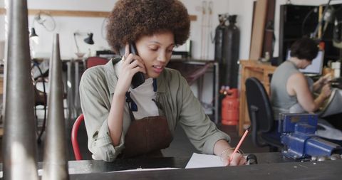 Jewelry designer creating new designs in creative workshop