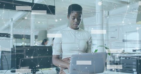 IT Professional Engaging with Technology in Open Office Setting