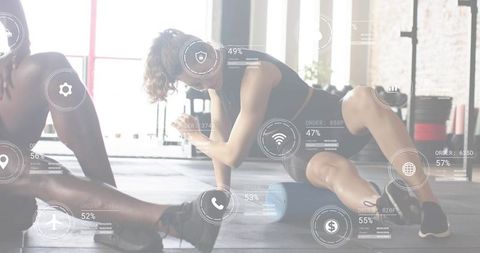 Female athlete using foam roller for mobility and recovery in sunlit gym with ar overlays