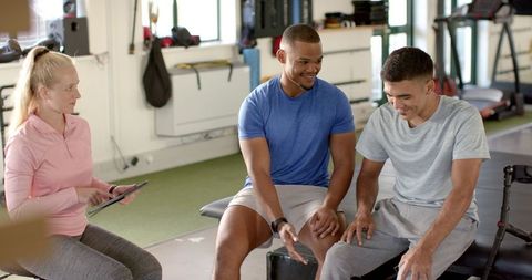 Physiotherapist Team Assisting Man with Disability in Rehabilitation Center