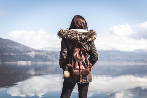 Woman With Backpack Enjoying Mountain Lake View