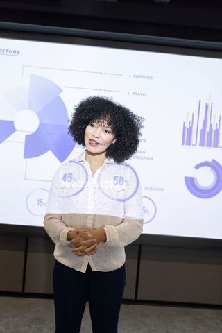 Woman delivering data presentation in corporate boardroom