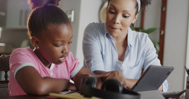 African American Mother Helping Daughter with Homework at Home - Download Free Stock Images Pikwizard.com