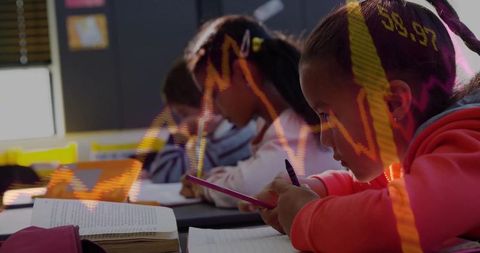 Focused Young Students Integrating Technology and Learning in Classroom Setting