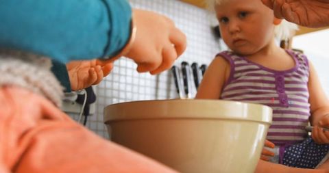 Father and Children Cooking Together in Home Kitchen