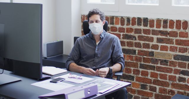 Office Worker Wearing Mask at Desk During Pandemic - Download Free Stock Images Pikwizard.com