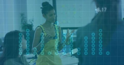 Female Presenter Leading Data-Driven Brainstorm in Modern Office with Digital Overlay