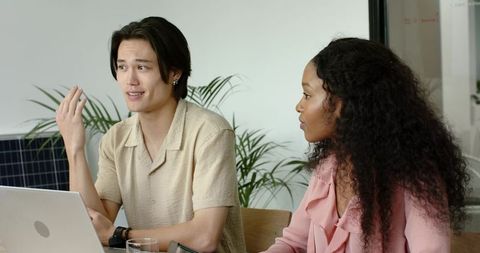 Diverse Team Discussing Business Concepts in Modern Office