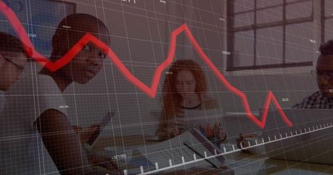 Team Analyzing Financial Data with Red Line Graph Overlay in Modern Office
