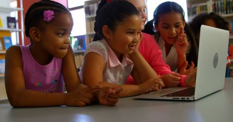 Diverse Schoolchildren Collaborating on Laptop in Library - Download Free Stock Images Pikwizard.com