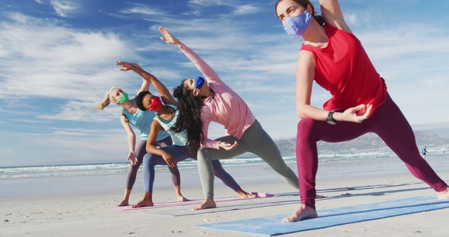 Group of diverse female friends wearing face masks practicing yoga at the beach - Download Free Stock Photos Pikwizard.com