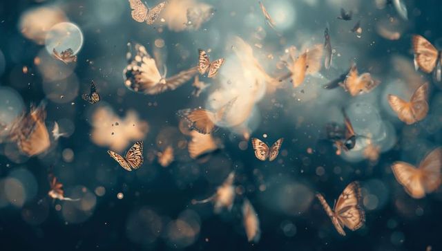 Fluttering orange-brown butterflies drifting through deep teal bokeh and golden light