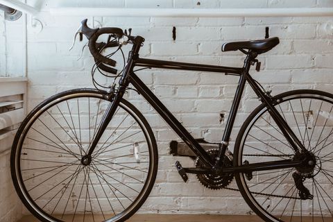 Vintage Black Bicycle Leaning Against White Brick Wall