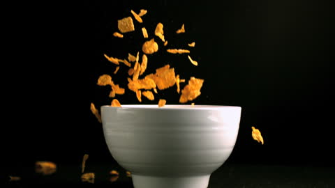 Slow Motion Cereal Pouring into Bowl Captures Breakfast Energy