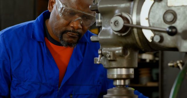 Experienced Industrial Worker Operating Heavy Machinery in Workshop - Download Free Stock Images Pikwizard.com